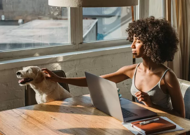 vrouw werkt thuis samen met hond